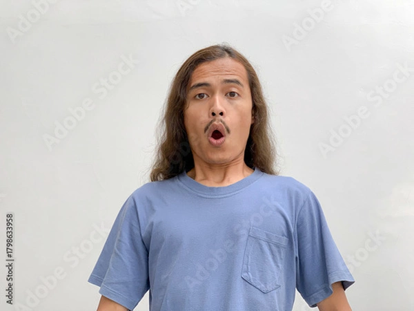 Fototapeta long haired man with a surprised expression