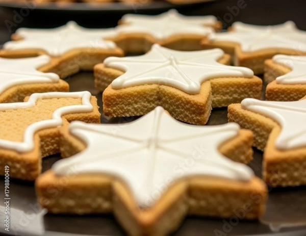 Fototapeta Star-Shaped Cookies with Icing Decor on a Dark Plate