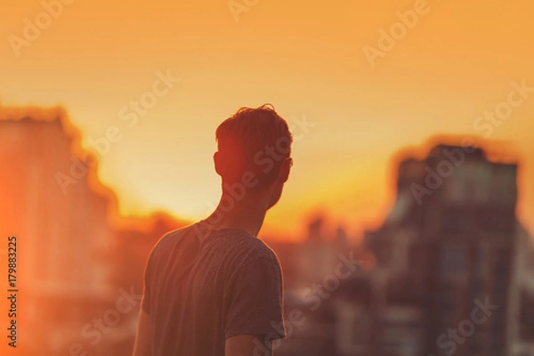 Fototapeta Man on the sunset background.