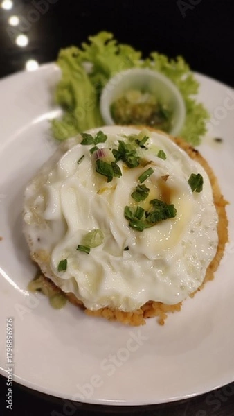 Obraz A close up picture of Fried Rice with Egg and salad in a white plate