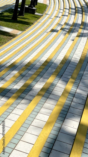Obraz Abstract yellow and white striped walkway in a park on a sunny day