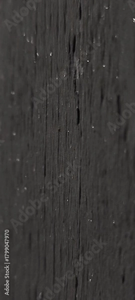 Fototapeta Close-up of a textured black wooden surface with visible grain patterns and small imperfections. Ideal for backgrounds or design elements.