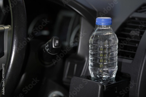 Fototapeta Drinking water in the car prepared for traveling