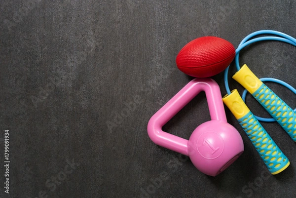 Fototapeta Time for exercising sport equipment on the black table background, healthy and workout concept