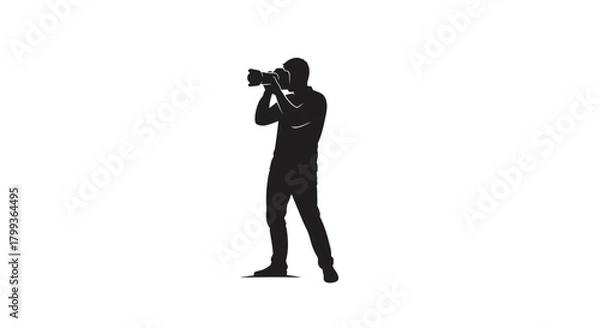 Fototapeta Silhouette of a photographer holding a large camera and taking a picture.