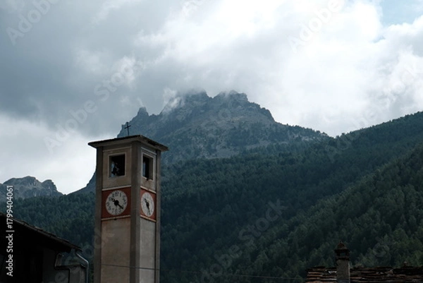 Fototapeta Bell tower of a mountain village in the Dolomites on a summer day in Trentino