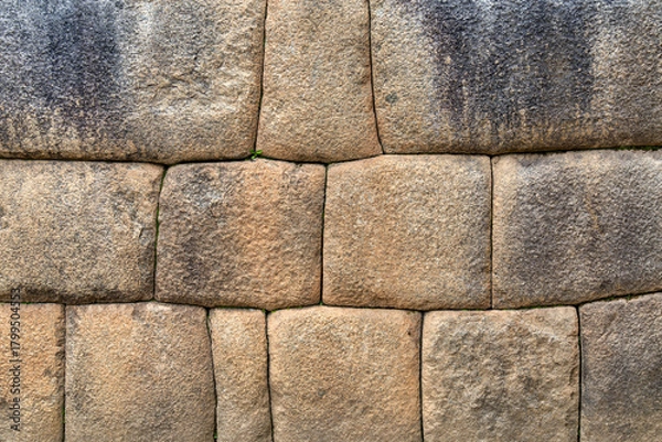 Obraz A detailed view of the precisely fitted stones forming an ancient Inca wall at Machu Picchu, Peru.