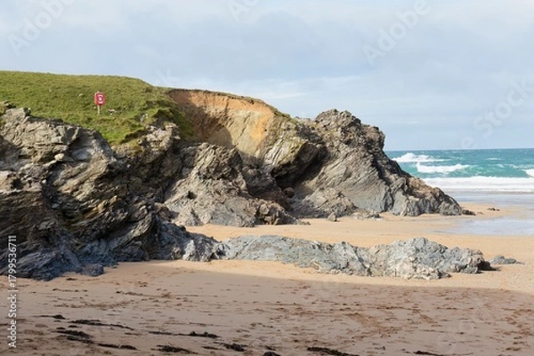 Fototapeta A landscape photo shows a rocky beach on a sunny day in Polly Joke - Cornwall - UK