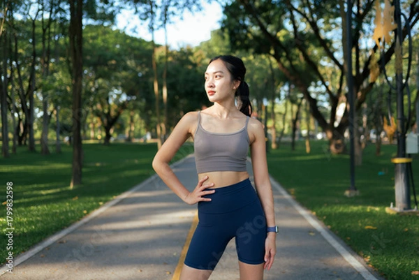 Obraz Asian woman taking a break from exercising in park