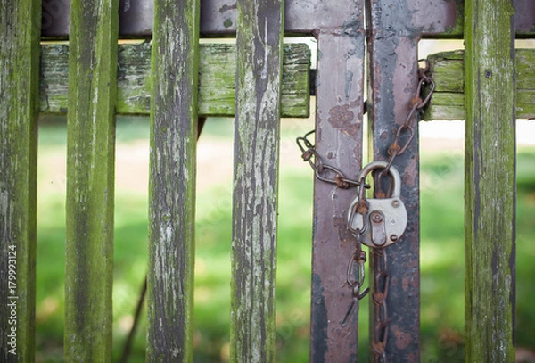 Obraz An old wooden fence closed with lock and chain