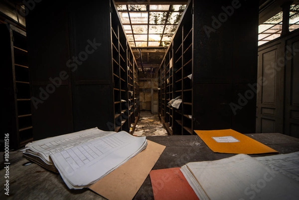 Fototapeta Derelict archive corridor with dusty files and broken skylight - moody abandoned office interior