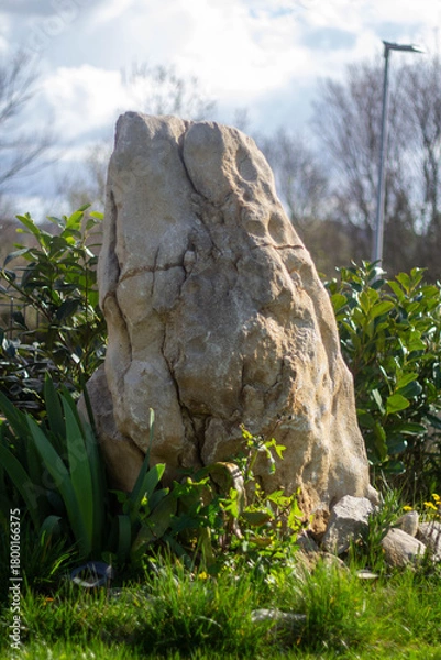 Fototapeta Garden decoration. A large stone in a green garden