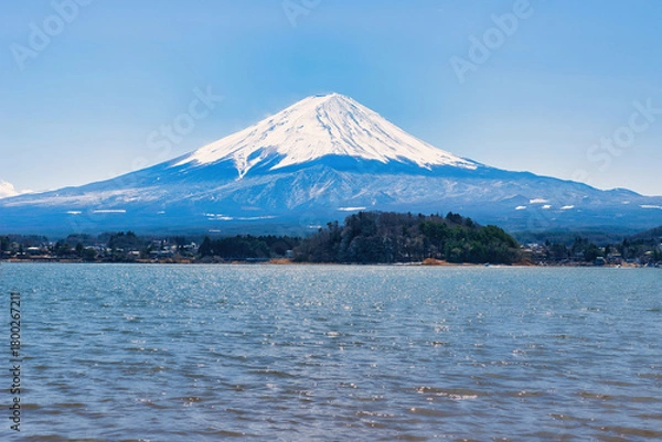 Fototapeta Lake Kawaguchiko, Japan - March 14 2025: Tourists enjoying the view of Lake Kawaguchiko with Mount Fuji in the background. Famous scenery of Mount Fuji in Japan. Blue skies on a cold sunny morning.