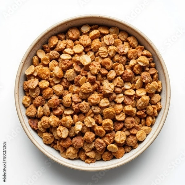 Obraz Overhead view of a rustic ceramic bowl filled with a generous portion of roasted hazelnuts on a clean white background
