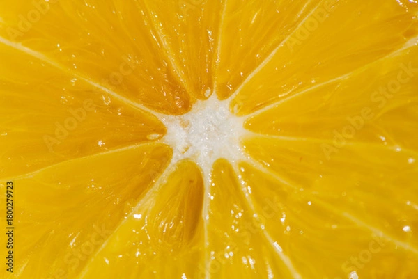 Fototapeta A vibrant yellow lemon resting on a table, captured in soft natural light. The image highlights the fruit’s bright color, fresh texture, and simple composition, making it suitable for food photography