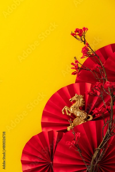 Obraz Golden horse statue on a red paper fan background with red plum blossoms against a bright yellow background. Ideal for Chinese New Year, year of the horse, or fortune themes.