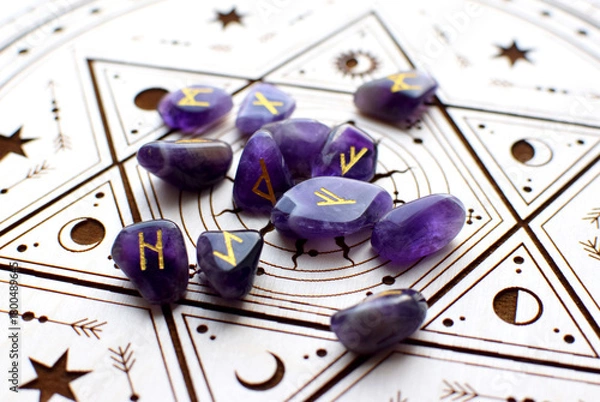 Obraz Scandinavian runes made of natural amethyst on a wooden altar for divination. Fortune telling, witchcraft, and spiritual esoteric practice.