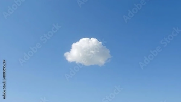 Fototapeta Single fluffy cloud in a vast blue sky, serene atmosphere.