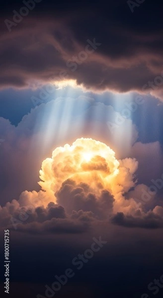 Obraz Sunlight breaking through dark clouds and illuminating a fluffy cloud formation in a dramatic sky scene