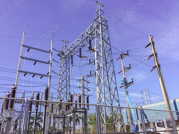 Fototapeta Maintenance service for high-voltage distribution systems, Electricity substation with blue sky backgound