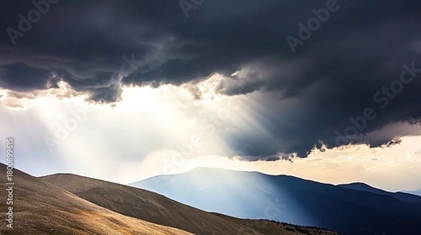Fototapeta overlooking. Majestic mountain peak at sunrise overlooking sea of clouds with golden light. travel magazines, destination branding, designed for travel destination branding.