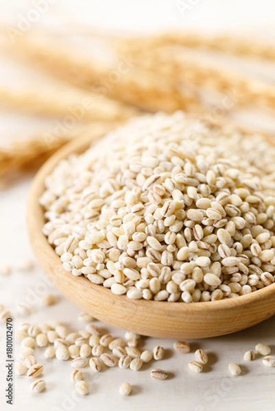 Obraz Closeup of barley grains in wooden cup.