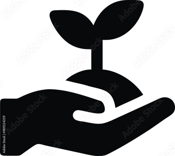 Obraz A gentle hand delicately holds a young plant sprouting from a mound