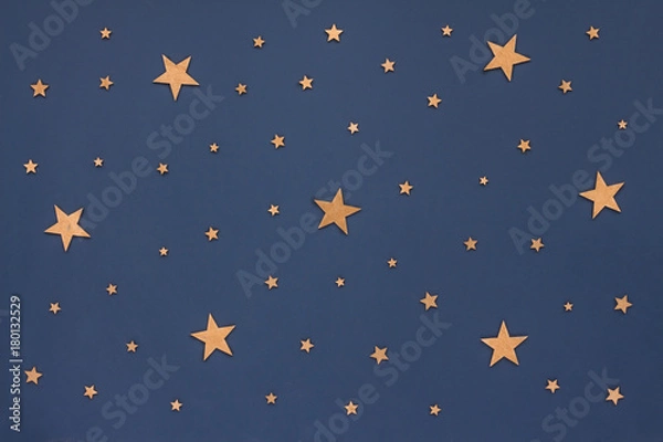 Obraz Christmas golden stars on dark blue background. Stars sky, flat lay, top view