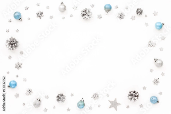 Obraz Christmas frame made of silver and blue christmas decoration, stars, pine cone, balls on white background, flat lay, top view
