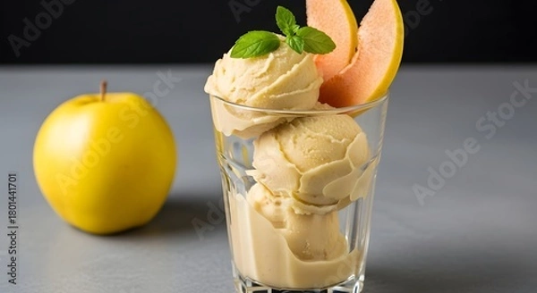 Obraz A refreshing apple sorbet served in a tall glass, garnished with a slice of quince for a fruity, elegant dessert