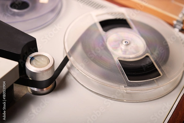 Fototapeta Vintage tape recorder plays music inside a cozy studio setting