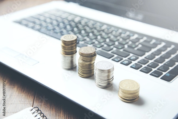 Fototapeta coins on computer keyboard