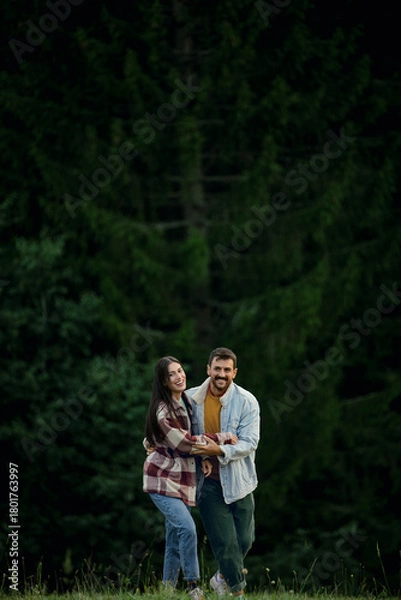 Obraz Happy couple enjoying nature smiling in forest