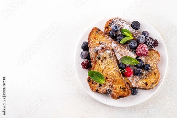 Obraz Leftover Christmas Spiced Stollen French Toasts, sweet fried stollen toasts with sugar powder and berries, Christmas morning dessert snack