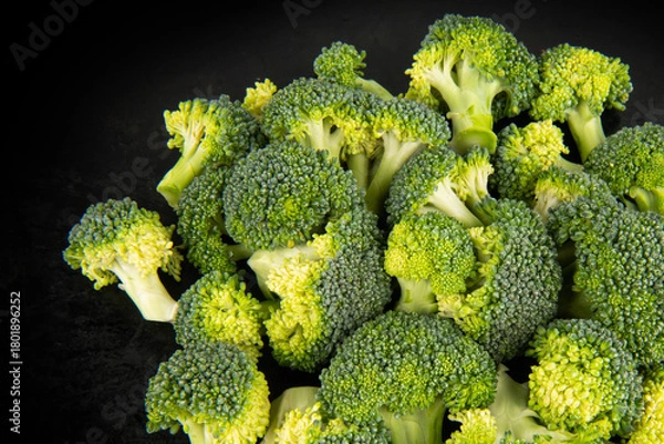 Obraz Fresh broccoli on a dark background. Top view.