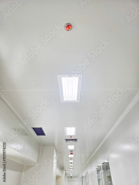 Obraz Perspective view of a white ceiling with lights and a fire alarm