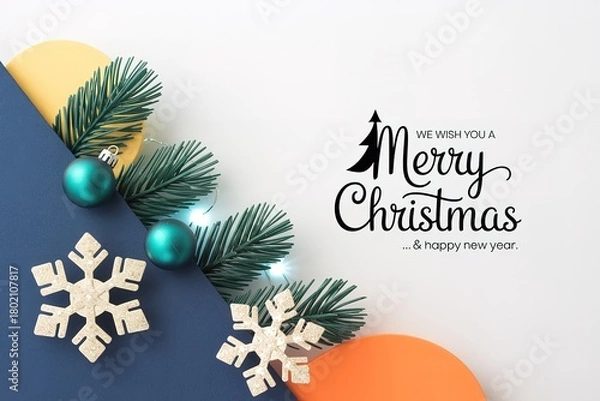 Obraz Evergreen boughs, turquoise ornaments, and paper snowflakes frame a holiday wish elegantly displayed