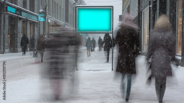 Fototapeta Winter street with crowd walking in snowfall and bright empty advertising board glowing in cold light, motion blur, concept of marketing, retail, promotion