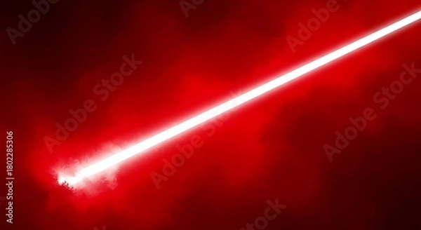 Fototapeta Vibrant red laser beam cutting through darkness creating a dramatic and intense visual effect