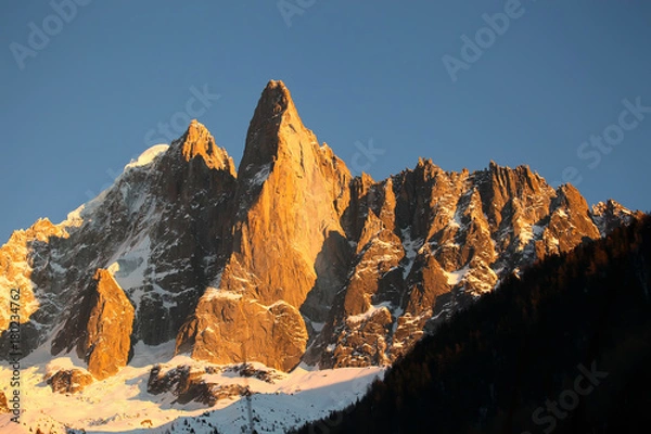 Fototapeta Sunset on the Aiguille du Dru and the Aiguille Verte seen from Les Praz, Chamonix, France.