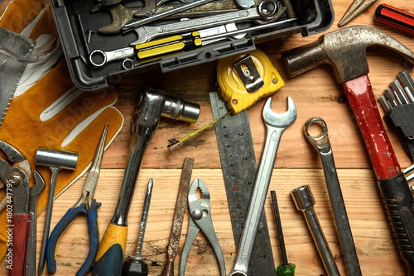 Fototapeta Assorted work tools on wooden board - DIY concept