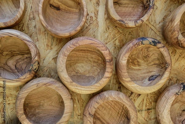 Fototapeta Wooden bowls arranged on a natural wooden surface showcasing fine craftsmanship, ideal for serving food or decorative purposes, created in a traditional workshop environment