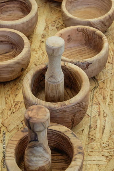 Fototapeta Handcrafted wooden mortars and pestles on display at a local market showcasing traditional craftsmanship from artisans