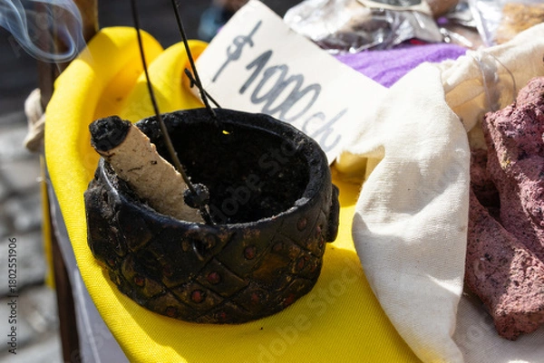 Fototapeta A piece of incense is inside a rustic incense holder; next to it is a price tag