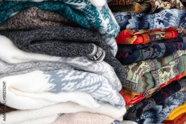 Fototapeta various pieces of clothing made of wool in different prints, folded into stacks