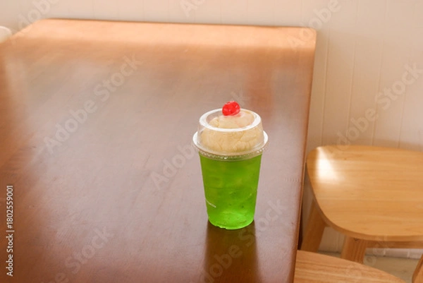 Obraz Melon soda float with vanilla ice cream and cherry on top in summer time,Melon soda is one of the most popular Japanese drink,Japanese cafe menu.