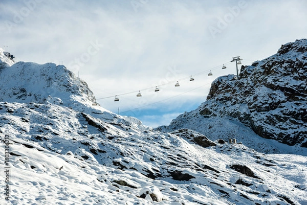 Fototapeta Ski LIft Climbs Hill Over First Snow Of The Year