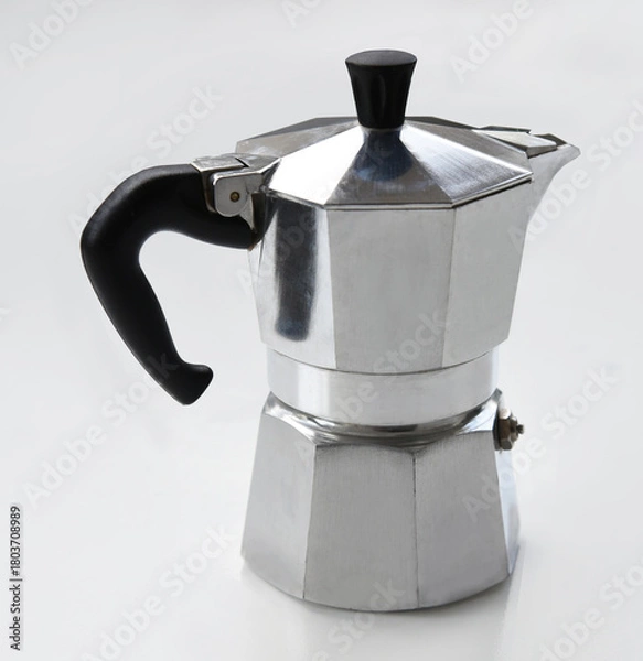 Obraz Classic silver moka pot isolated on a white background. Vintage Italian coffee maker with black handle, ideal for brewing espresso at home. Perfect for kitchen, cafe or coffee-themed design.