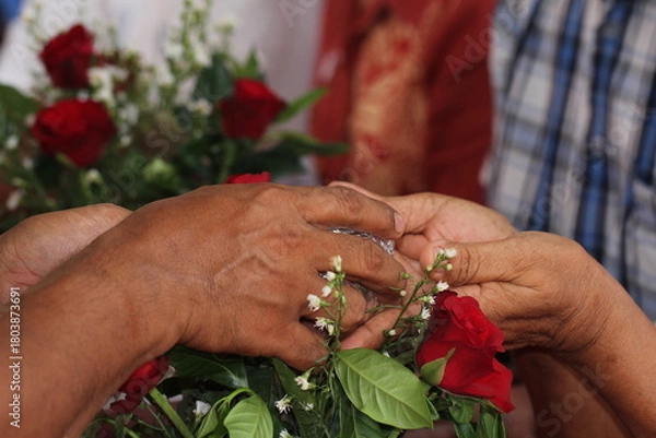 Fototapeta Close - up of hands of Thai pour water on elders' hands for blessings, Songkran Festival