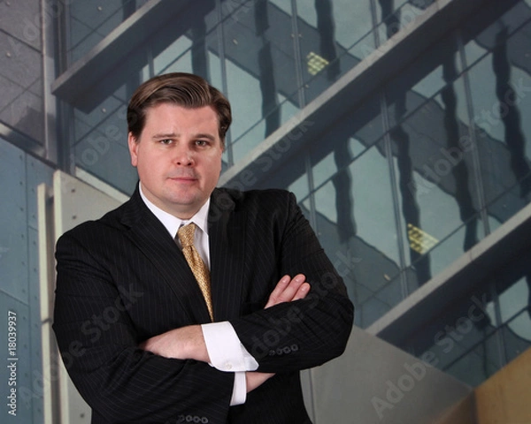 Fototapeta Businessman in front of an office building